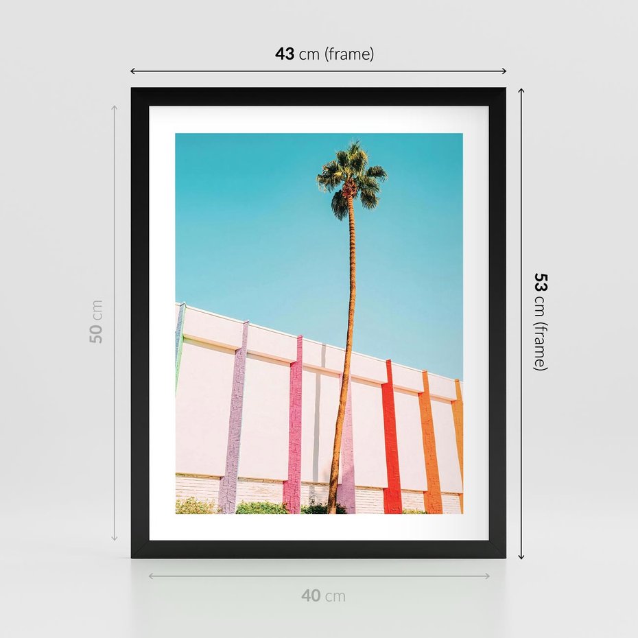 Plakat w ramie 40x50 - Tropikalny Kontrast - palma na tle błękitnego nieba, kolorowy mur - rama czarna