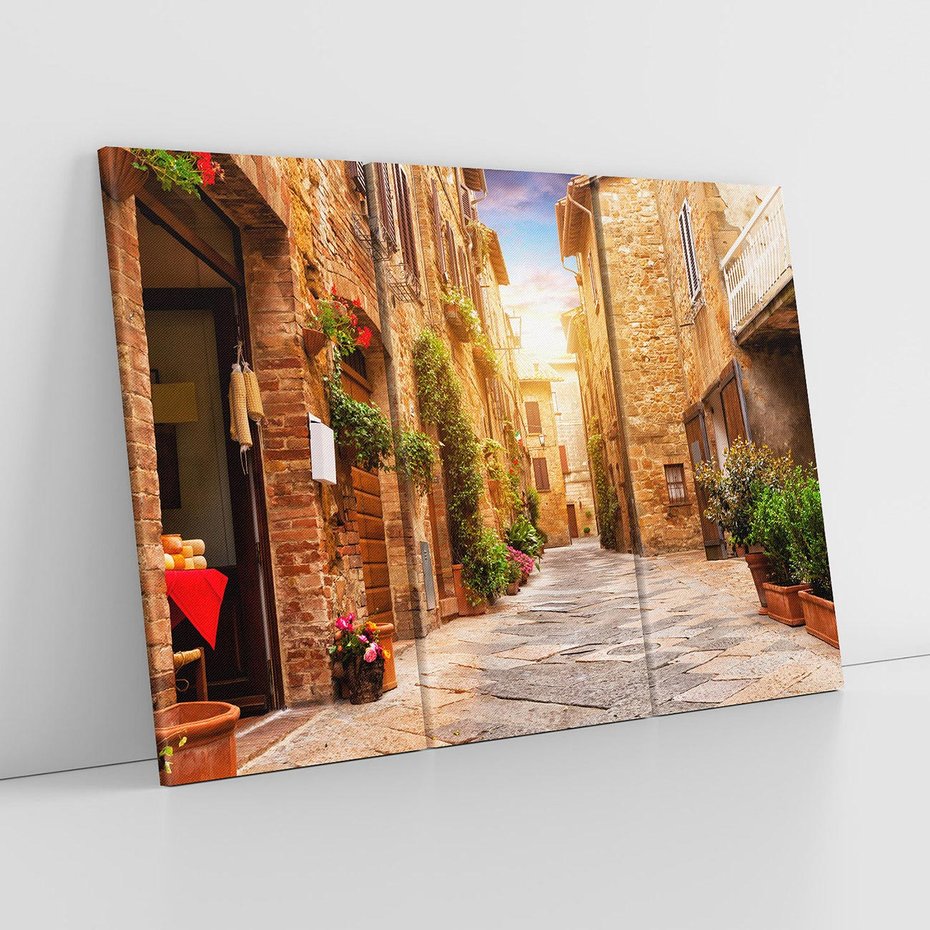 Obraz na płótnie 120x80 - Urok uliczki miejskiej z kwiatami - sklep, uliczka