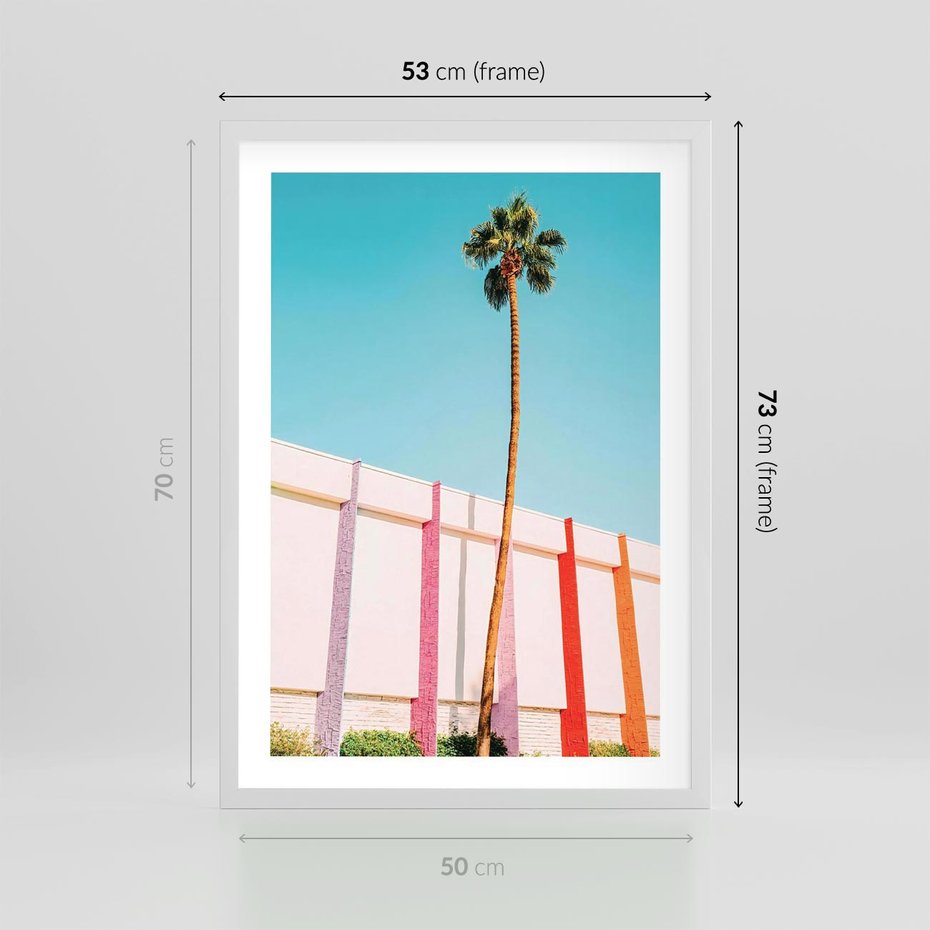 Plakat w ramie 50x70 - Tropikalny Kontrast - palma na tle błękitnego nieba, kolorowy mur - rama biała