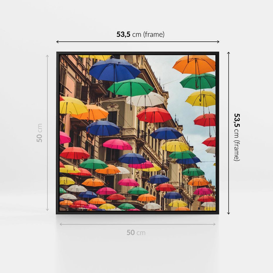Obraz w ramie 50x50 - Barwna symfonia wyobraźni - fotografia, kolorowe parasolki podwieszone nad ulicą - rama czarna