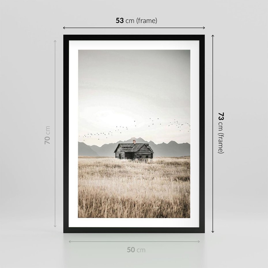 Plakat w ramie 50x70 - Wiejska Idylla - stary drewniany dom w polu suchej trawy, fotografia - rama czarna