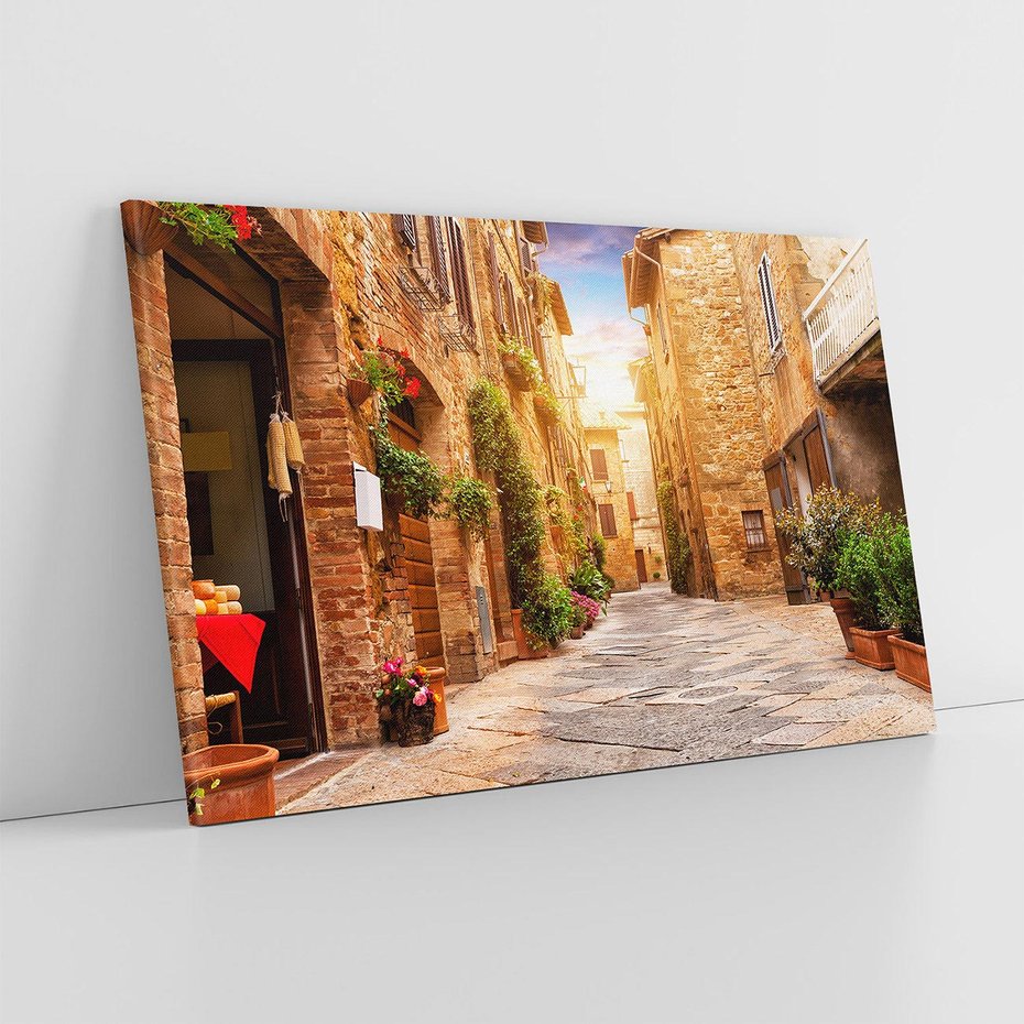 Obraz na płótnie 100x70 - Urok uliczki miejskiej z kwiatami - sklep, uliczka