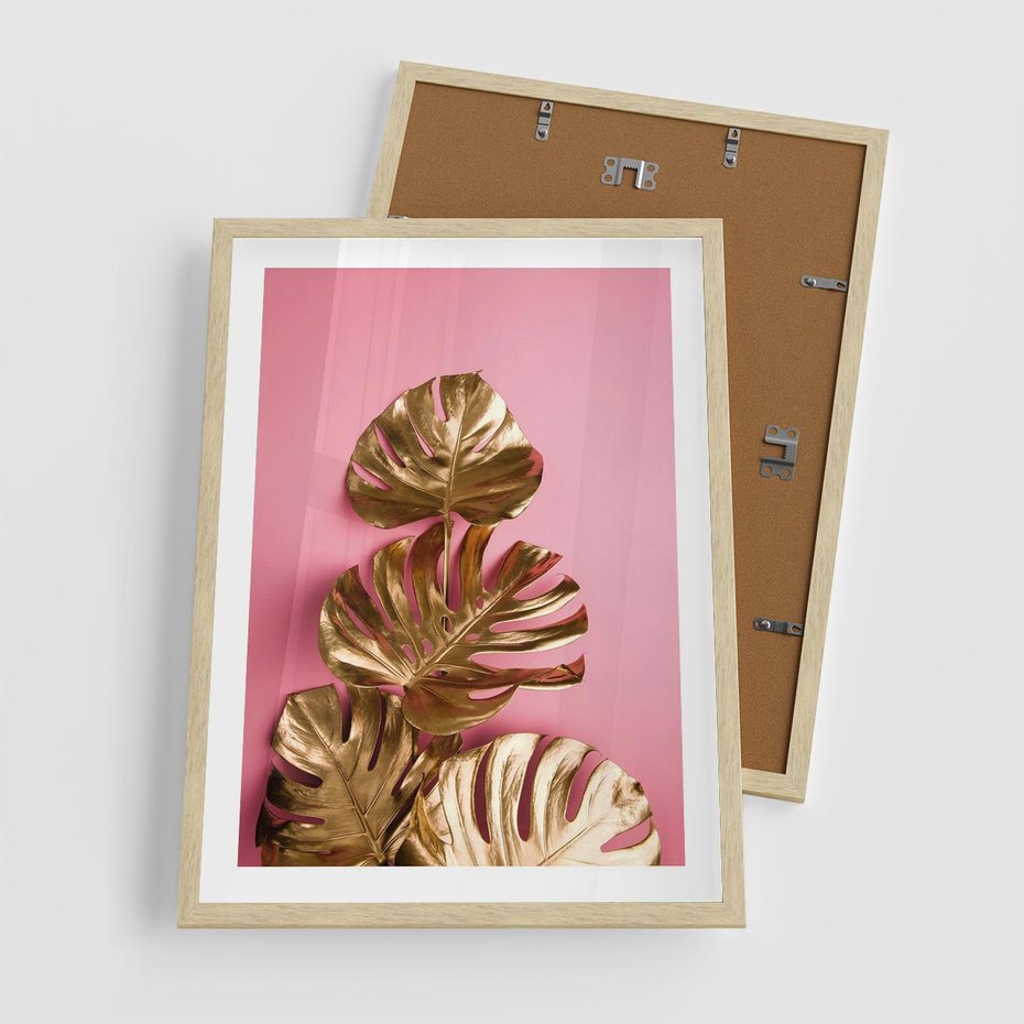 Plakat w ramie 50x70 - Złote Liście Monstery: Delikatność na Różowym Tle - złote liście monstery, różowe tło - rama drewno