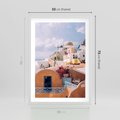 Plakat w ramie 50x70 - Błękit Morza i Białe Domki - Santorini, wyspa - rama biała