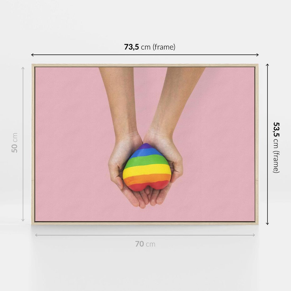 Obraz w ramie 70x50 - Miłość na Dłoniach - zdjęcie, dłonie trzymają ulepione tęczowe serce - rama drewno