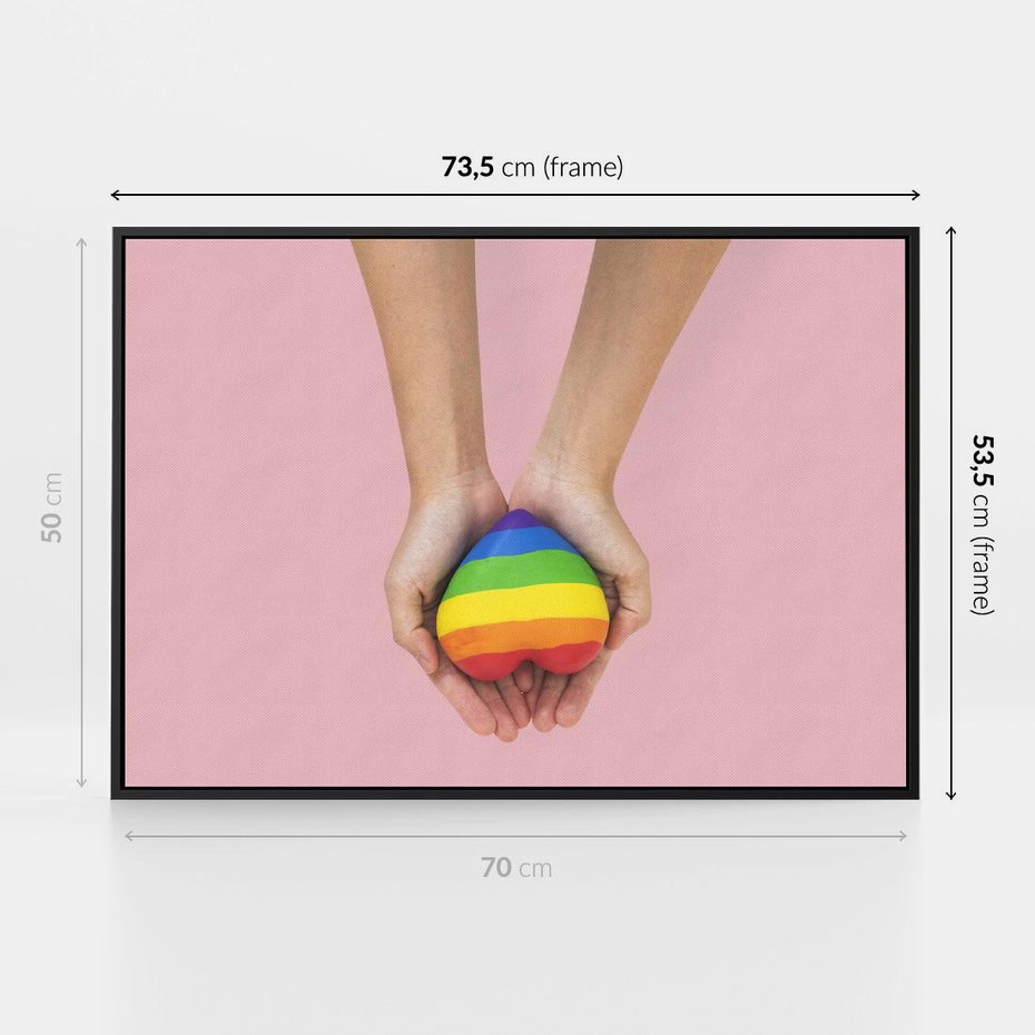Obraz w ramie 70x50 - Miłość na Dłoniach - zdjęcie, dłonie trzymają ulepione tęczowe serce - rama czarna