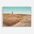 Obraz w ramie 100x70 - Tajemnicza Ścieżka - latarnia morska w oddali, suche trawy - rama biała