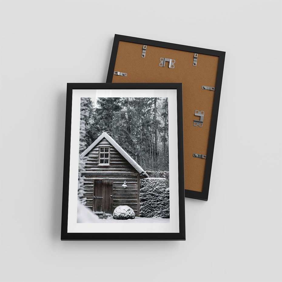 Plakat w ramie 30x40 - Zaklęta Zima - domek w lesie, śnieg - rama czarna