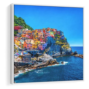 Obraz w ramie 50x50 - Barwne Wybrzeże - nadmorskie miasto na klifie, kolorowe tęczowe budynki - rama biała