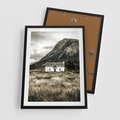 Plakat w ramie 50x70 - Biały Domek w Sepii: Wiejski Urok - domek w górach, kolory sepii - rama czarna