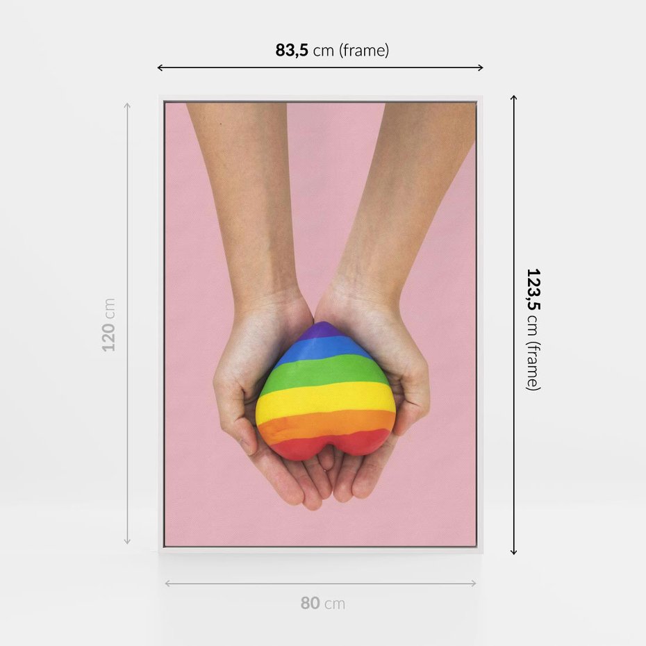 Obraz w ramie 80x120 - Miłość na Dłoniach - zdjęcie, dłonie trzymają ulepione tęczowe serce - rama biała
