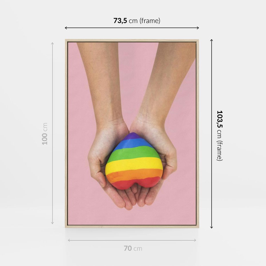Obraz w ramie 70x100 - Miłość na Dłoniach - zdjęcie, dłonie trzymają ulepione tęczowe serce - rama drewno