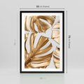 Plakat w ramie 50x70 - Złote Akcenty w Fotografii - złotel liście monstery, na białym tle - rama czarna