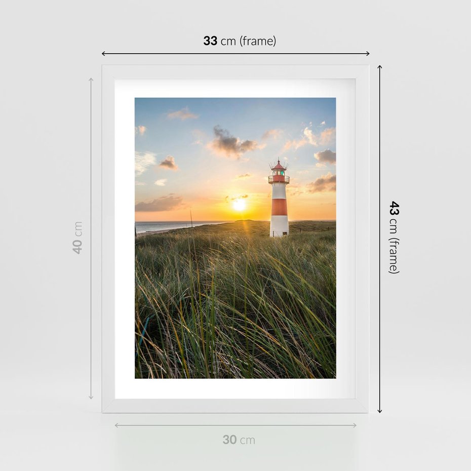 Plakat w ramie 30x40 - Magia latarni przy zachodzie - latarnia, zachód - rama biała