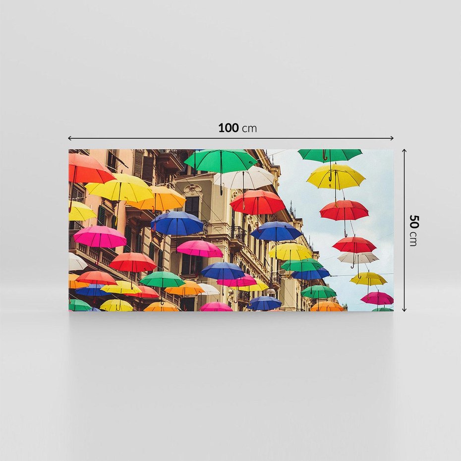 Obraz na płótnie 100x50 - Barwna symfonia wyobraźni - fotografia, kolorowe parasolki podwieszone nad ulicą