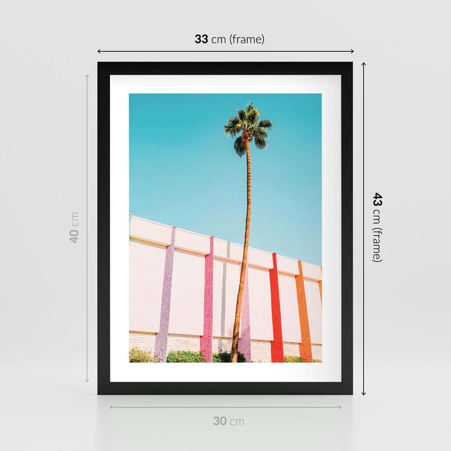 Plakat w ramie 30x40 - Tropikalny Kontrast - palma na tle błękitnego nieba, kolorowy mur - rama czarna