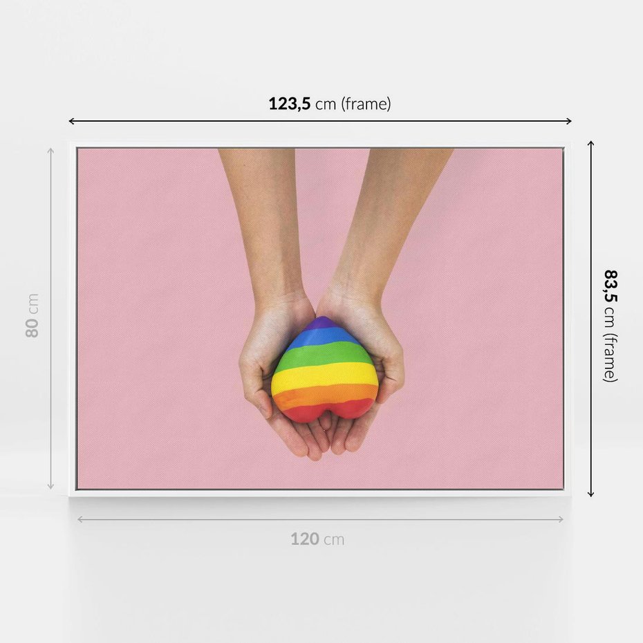 Obraz w ramie 120x80 - Miłość na Dłoniach - zdjęcie, dłonie trzymają ulepione tęczowe serce - rama biała