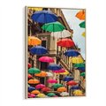 Obraz w ramie 80x120 - Barwna symfonia wyobraźni - fotografia, kolorowe parasolki podwieszone nad ulicą - rama drewno