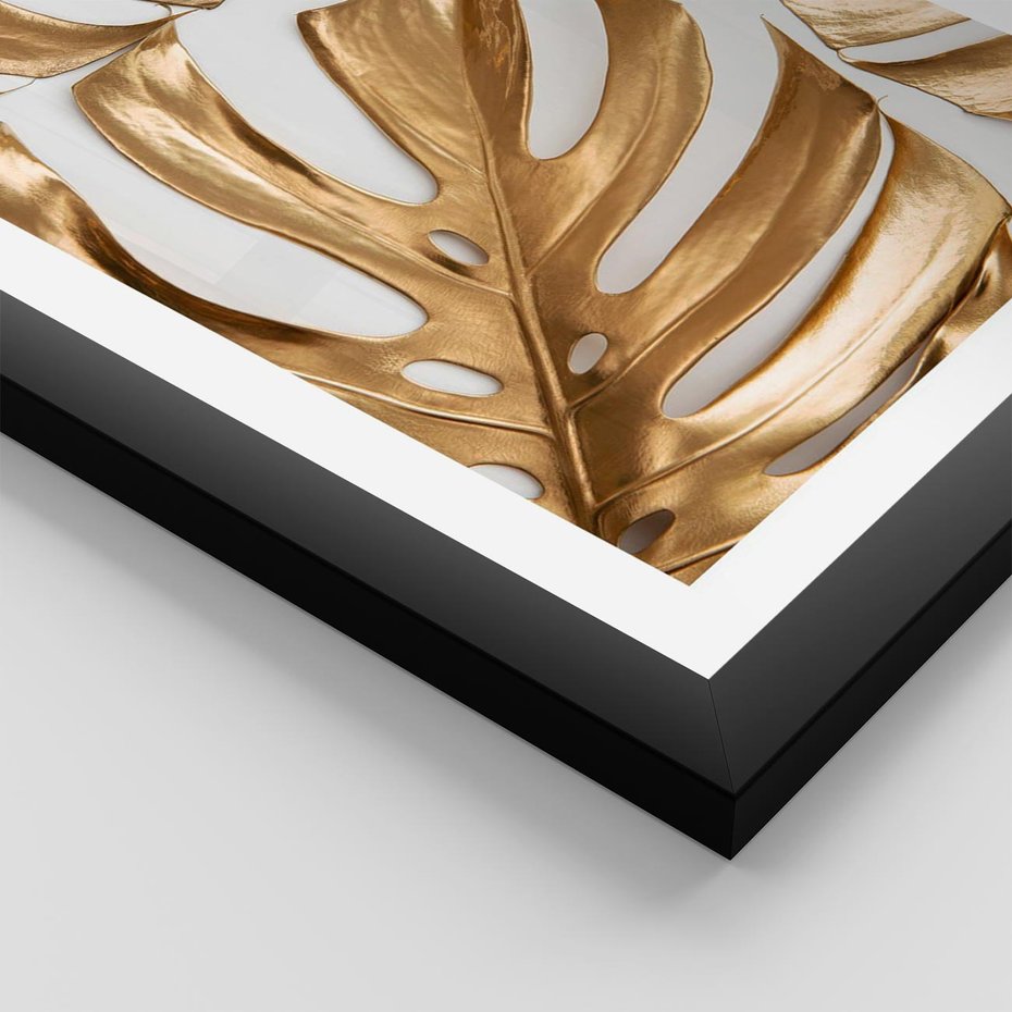 Plakat w ramie 50x70 - Złote Akcenty w Fotografii - złotel liście monstery, na białym tle - rama czarna