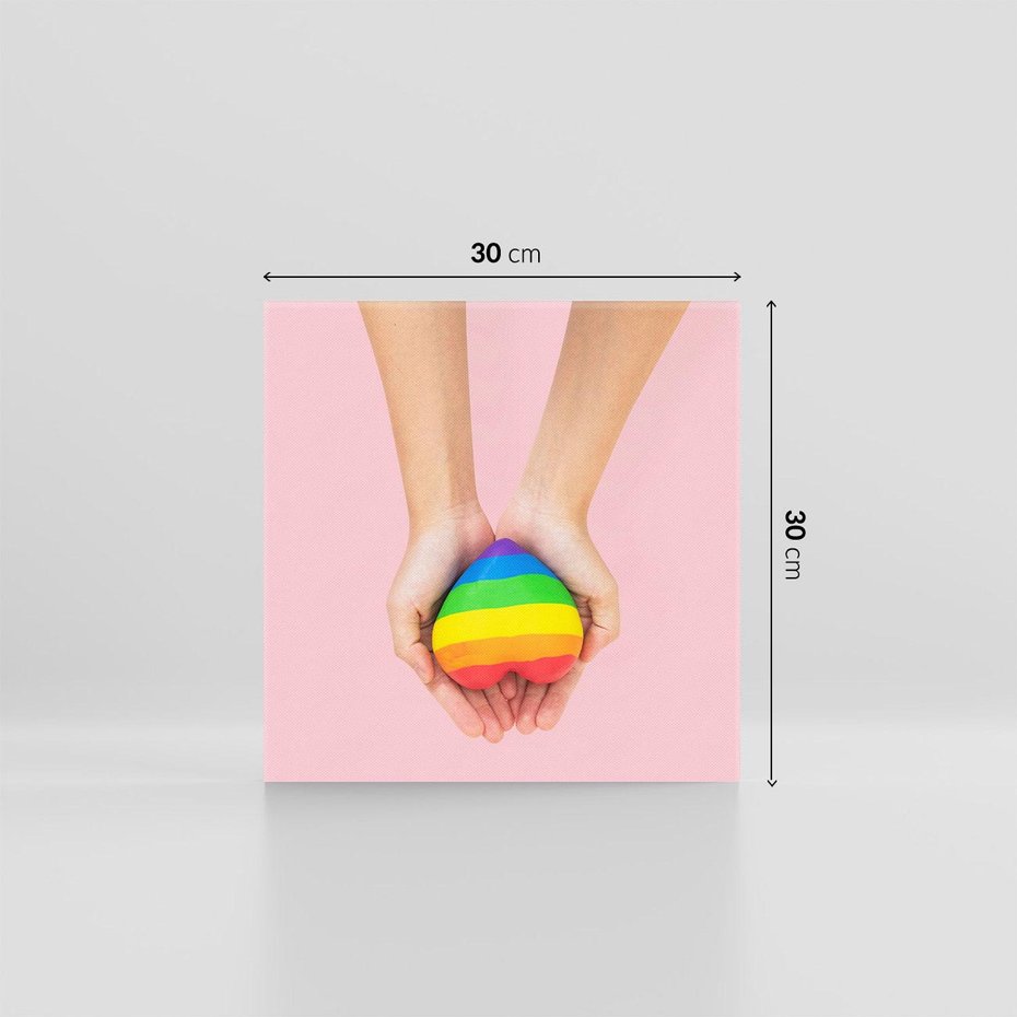 Obraz na płótnie 30x30 - Miłość na Dłoniach - zdjęcie, dłonie trzymają ulepione tęczowe serce