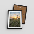 Plakat w ramie 30x40 - Magia latarni przy zachodzie - latarnia, zachód - rama czarna