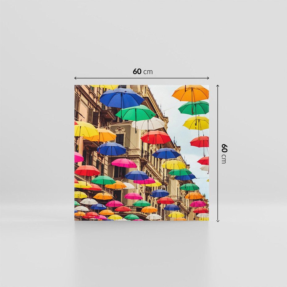 Obraz na płótnie 60x60 - Barwna symfonia wyobraźni - fotografia, kolorowe parasolki podwieszone nad ulicą