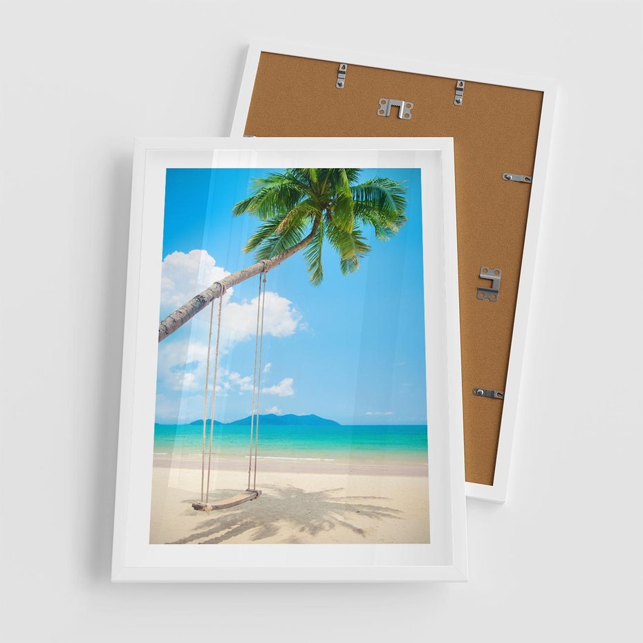 Plakat w ramie 50x70 - Hawajska palma i huśtawka na plaży - palma, huśtawka - rama biała