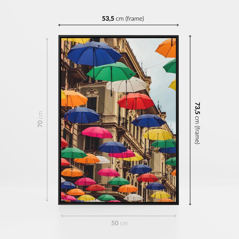 Obraz w ramie 50x70 - Barwna symfonia wyobraźni - fotografia, kolorowe parasolki podwieszone nad ulicą - rama czarna