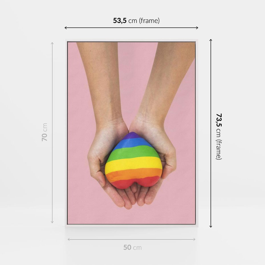 Obraz w ramie 50x70 - Miłość na Dłoniach - zdjęcie, dłonie trzymają ulepione tęczowe serce - rama biała