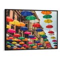 Obraz w ramie 70x50 - Barwna symfonia wyobraźni - fotografia, kolorowe parasolki podwieszone nad ulicą - rama czarna
