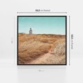 Obraz w ramie 50x50 - Tajemnicza Ścieżka - latarnia morska w oddali, suche trawy - rama czarna