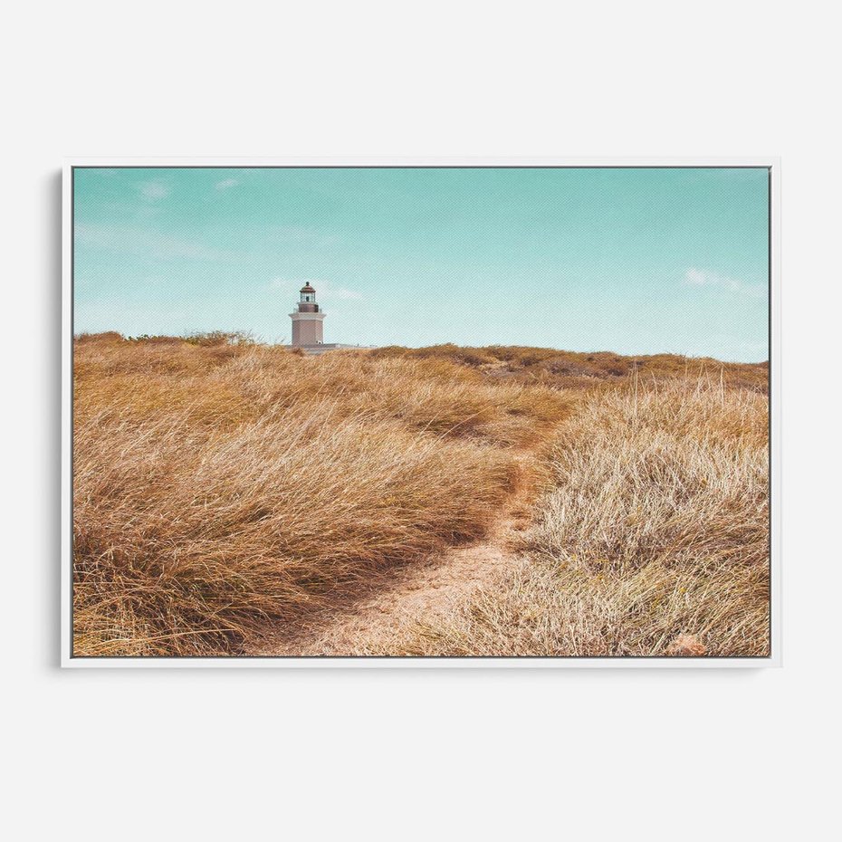 Obraz w ramie 120x80 - Tajemnicza Ścieżka - latarnia morska w oddali, suche trawy - rama biała