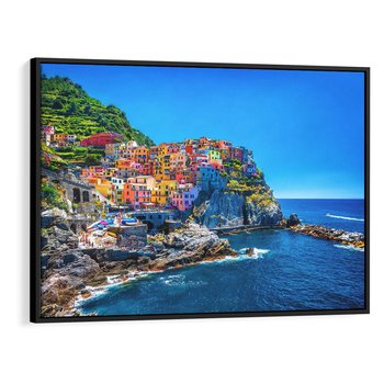 Obraz w ramie 70x50 - Barwne Wybrzeże - nadmorskie miasto na klifie, kolorowe tęczowe budynki - rama czarna