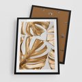 Plakat w ramie 50x70 - Złote Akcenty w Fotografii - złotel liście monstery, na białym tle - rama czarna