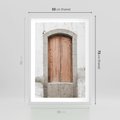 Plakat w ramie 50x70 - Śródziemnomorskie Drzwi Czasu - fotografia starych drzwi, śródziemnomorska architektura - rama biała
