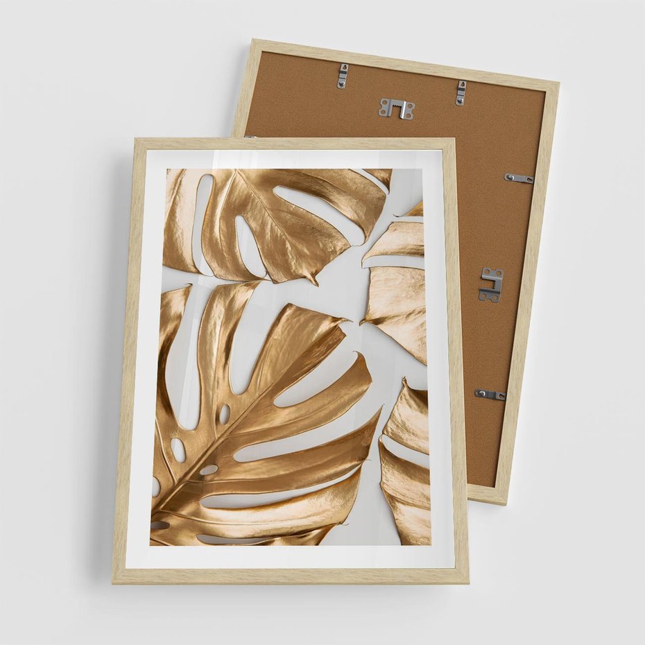 Plakat w ramie 50x70 - Złote Akcenty w Fotografii - złotel liście monstery, na białym tle - rama drewno