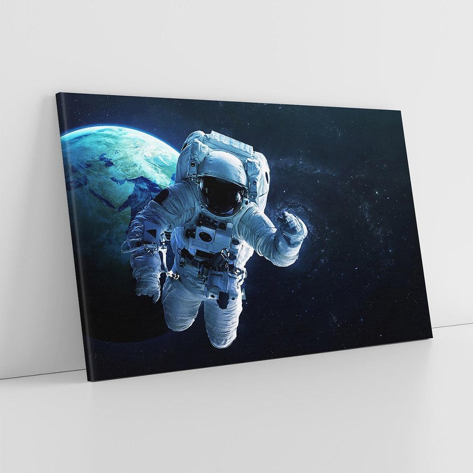Obraz na płótnie 70x50 - kosmiczna podróż - kosmonauta, ziemia