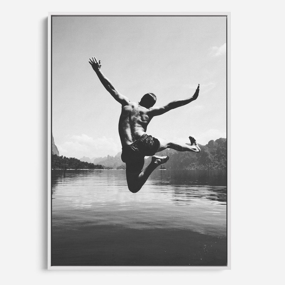 Obraz w ramie 50x70 - Beztroska Chwila - czarno biała fotografia, mężczyzna wesoło wskakuje do keziora w górach - rama biała