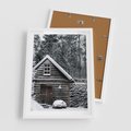 Plakat w ramie 50x70 - Zaklęta Zima - domek w lesie, śnieg - rama biała