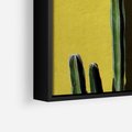 Obraz w ramie 70x50 - Refleksje w roślinnym odbiciu - zielone kaktusy na tle żółtej ściany, soczyste kolory - rama czarna