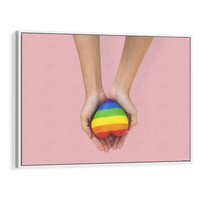 Obraz w ramie 70x50 - Miłość na Dłoniach - zdjęcie, dłonie trzymają ulepione tęczowe serce - rama biała