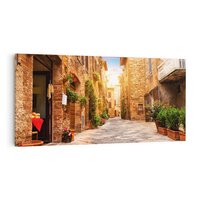 Obraz na płótnie 140x70 - Urok uliczki miejskiej z kwiatami - sklep, uliczka