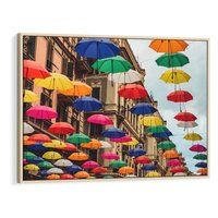 Obraz w ramie 100x70 - Barwna symfonia wyobraźni - fotografia, kolorowe parasolki podwieszone nad ulicą - rama drewno