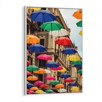 Obraz w ramie 50x70 - Barwna symfonia wyobraźni - fotografia, kolorowe parasolki podwieszone nad ulicą - rama biała