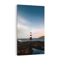 Obraz na płótnie 70x100 - Zachód słońca nad morzem: Magia plażowej scenerii - latarnia morska, morze